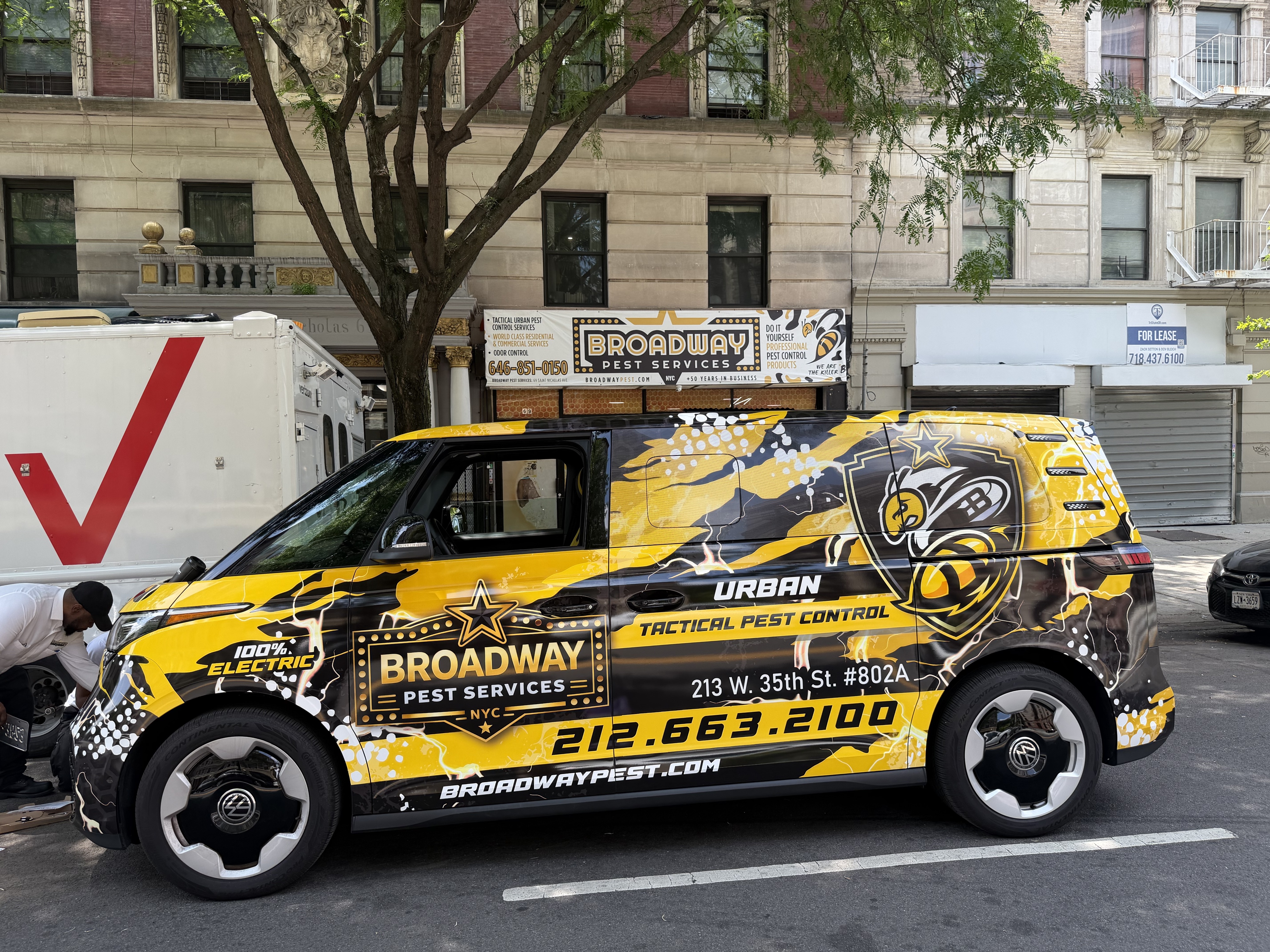 Broadway Pest Services 100% electric Volkswagen ID. Buzz tactical wrap on a NYC street